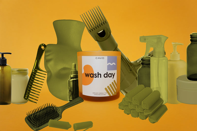 Photo of Wash Day Candle in collage style surrounded by hair product containers, wig head, brushes, spray bottles, blow dryer, etc.